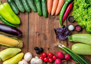 The multicolored vegetables on wooden table