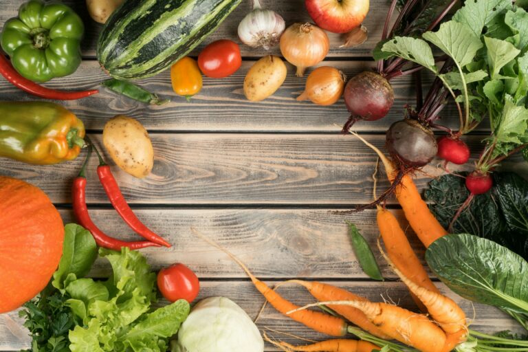 Colorful mix of vegetables and fruits, top view. Sorting organic ripe harvest on wooden table. Nitra